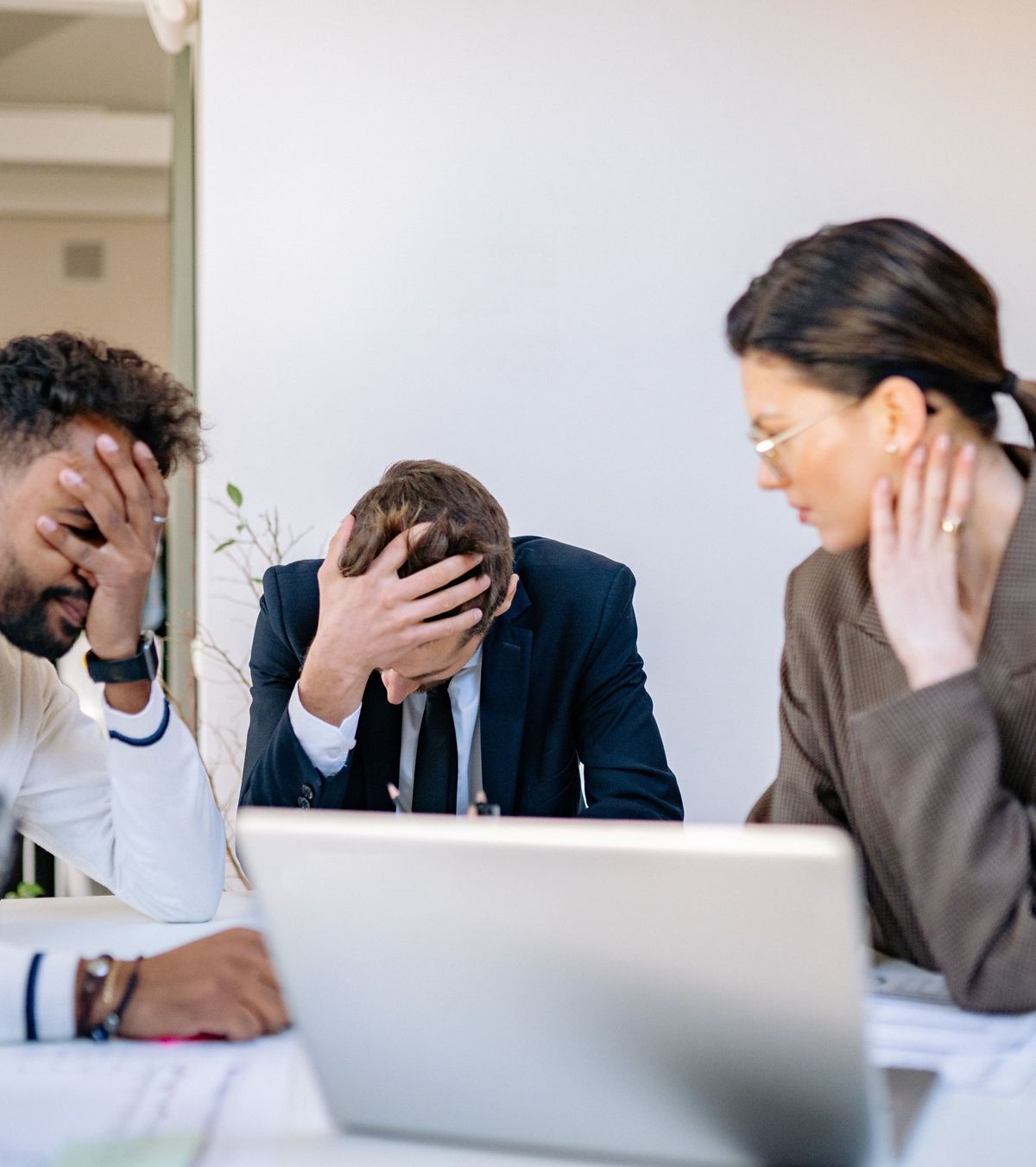 Colleagues looking frustrated at a laptop